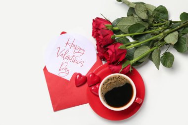 Letter with text HAPPY VALENTINE'S DAY, roses, cup of coffee and candies on white background