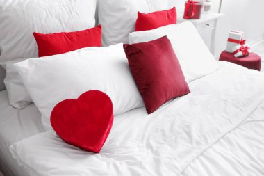 Big bed with gift for Valentine's Day in bedroom