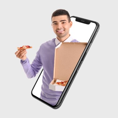 Man with pizza box looking out of phone screen on light background