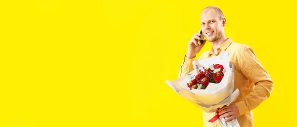 Young Man Bouquet Flowers Talking Mobile Phone Yellow Background Space — Stock Photo, Image