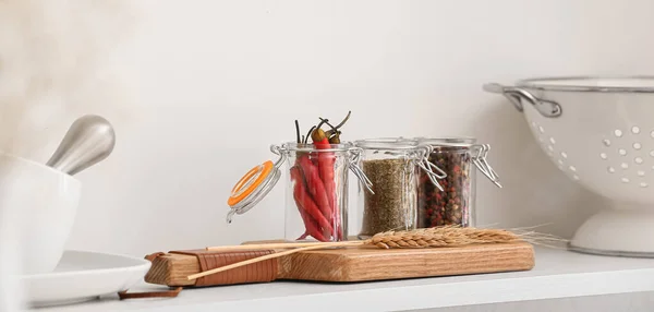 stock image Jars with different spices on shelf in kitchen