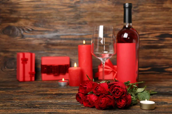 Red Roses Burning Candles Gifts Bottle Wine Wooden Background Closeup — Photo