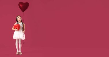 Funny little girl with gift and balloon on color background with space for text. Valentine's Day celebration