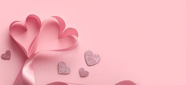 Hearts made of ribbon on pink background with space for text. Valentine's Day celebration