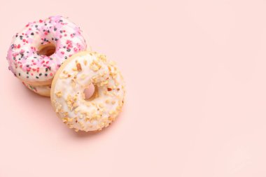 Tasty donuts on pink background