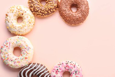 Different sweet donuts on pink background