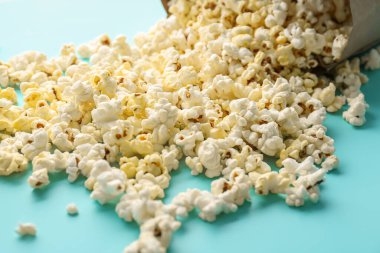 Scattered popcorn on color background, closeup