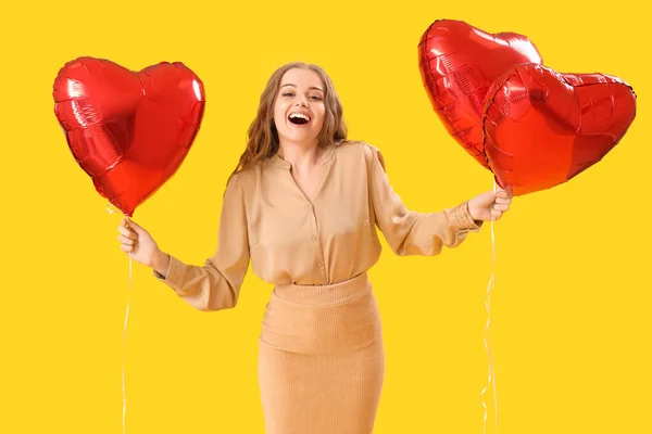 Beautiful Young Woman Heart Shaped Balloons Yellow Background Valentine Day — Stock Photo, Image