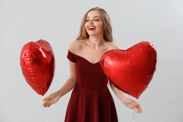 Happy Young Woman Heart Shaped Balloons Light Background Valentine Day — Stock Photo, Image