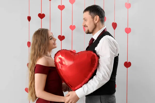 Happy Young Couple Heart Shaped Balloon Light Background Valentine Day — Stock Photo, Image