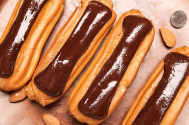 Plate with delicious chocolate eclairs, closeup