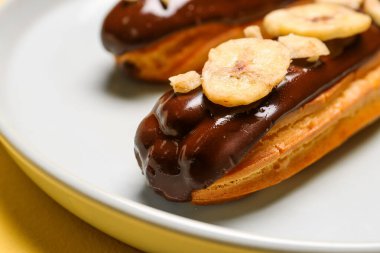 Plate with sweet eclairs, closeup