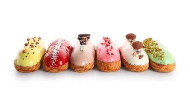 Various glazed eclairs isolated on white background