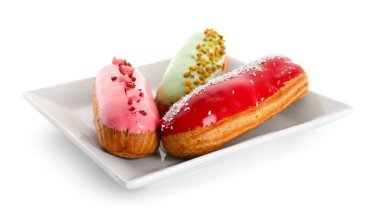 Plate with various glazed eclairs isolated on white background