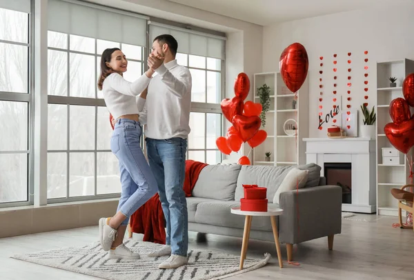 Happy couple in love dancing at home on Valentine\'s Day