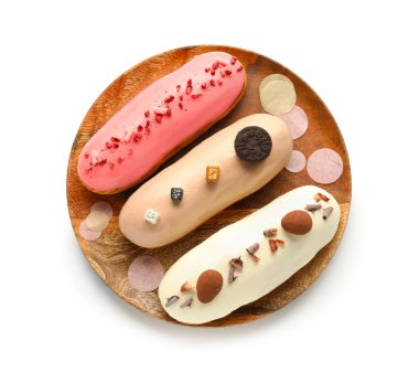 Plate with various glazed eclairs isolated on white background