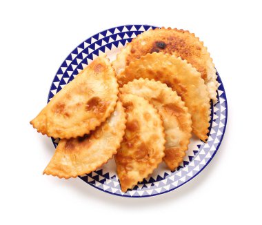 Plate with tasty chebureks on white background