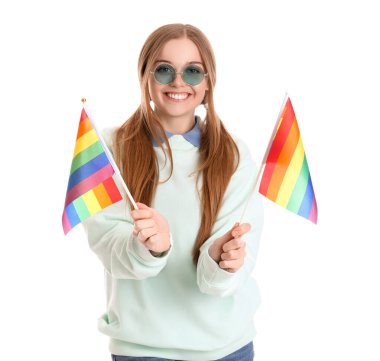 Beautiful young woman in sunglasses with LGBT flags on white background