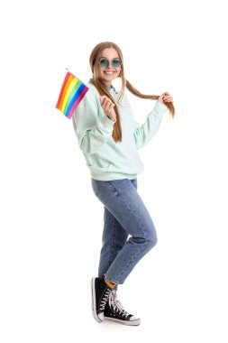 Beautiful young woman in sunglasses with LGBT flag on white background