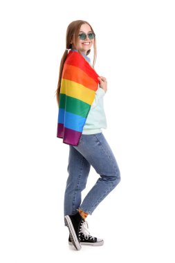 Beautiful young woman in sunglasses with LGBT flag on white background