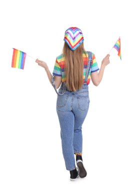 Young woman with LGBT flags on white background, back view