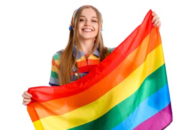 Beautiful young woman with LGBT flag on white background