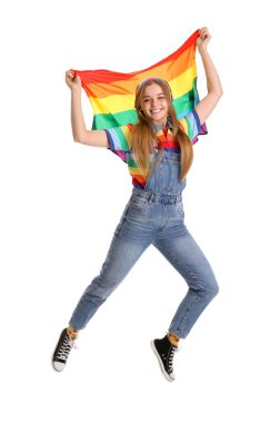 Beautiful young woman with LGBT flag jumping on white background