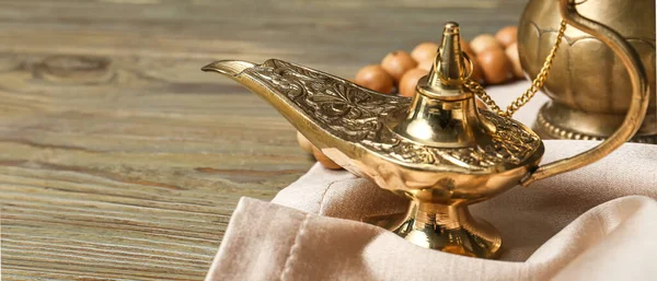 Aladdin lamp of wishes on wooden table, closeup