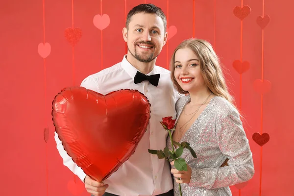 Happy Young Couple Heart Shaped Balloon Rose Red Background Valentine — Stock Photo, Image