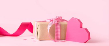 Beautiful gift box and heart on pink background. Valentine's Day celebration