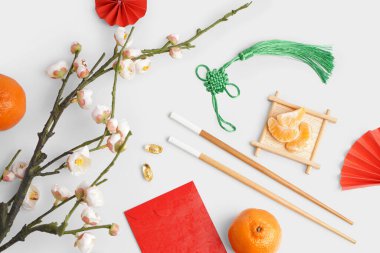 Red envelope, mandarins and Chinese symbols on white background