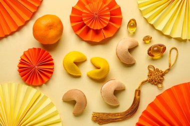 Fortune cookies with mandarin and Chinese symbols on yellow background. New Year celebration