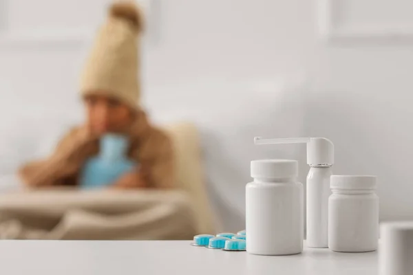 Different medicines on table in bedroom of ill boy, closeup