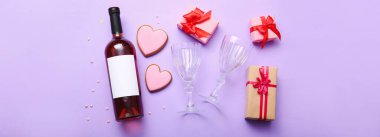 Bottle of wine, glasses, heart shaped cookies and gifts for Valentines Day on lilac background