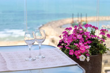 Table with wine glasses on balcony, closeup