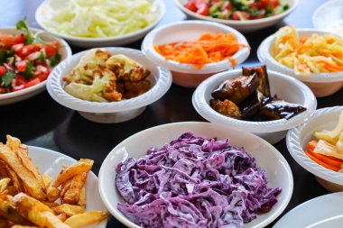 Plates with tasty food on black table, closeup