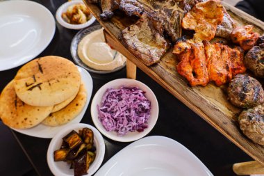 Plates with tasty food on black table, closeup