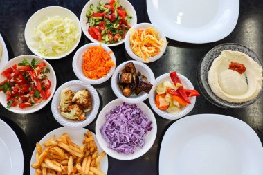 Plates with tasty food on black table, closeup