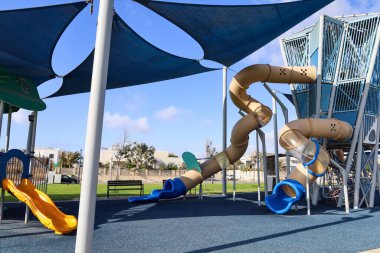 View of children's playground with slide on sunny day