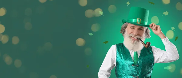 Happy senior man with big head and smoking pipe on green background with space for text. St. Patrick\'s Day celebration