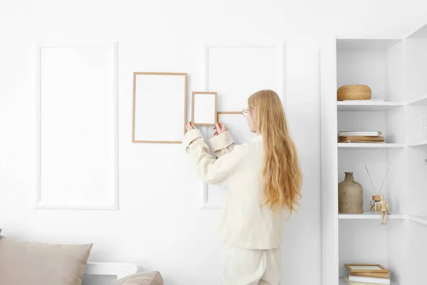Blonde Woman Hanging Blank Photo Frame White Wall Home — Stock Photo, Image