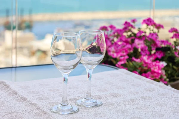 Table with wine glasses on balcony, closeup