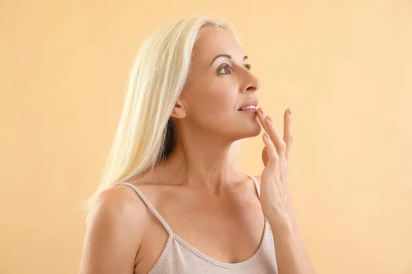 Mature Blonde Woman Touching Her Lip Beige Background — Stock Photo, Image