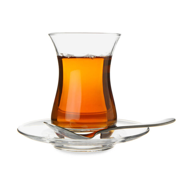 Glass of Turkish tea with spoon on white background