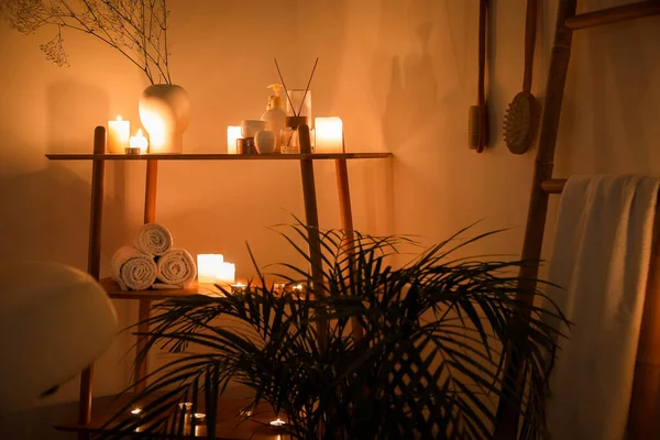 Interior Dark Spa Salon Shelving Unit Burning Candles Palm Tree — Stock Photo, Image