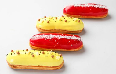 Delicious glazed eclairs isolated on white background