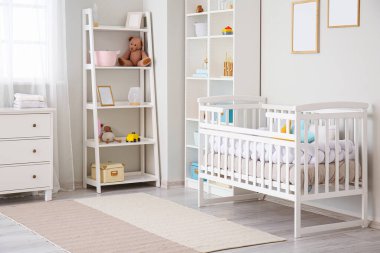 Stylish interior of children's room with baby bed