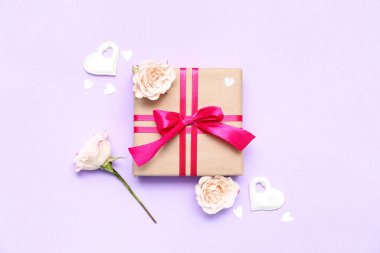 Composition with beautiful gift, decor and flowers on color background. Valentine's Day celebration