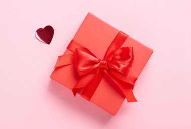 Gift box with beautiful bow on pink background. Valentine's Day celebration