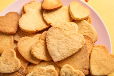 Plate with tasty heart shaped cookies, closeup. Valentines Day celebration